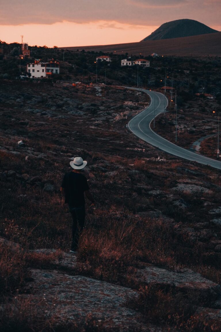 A solitary traveler walks along a winding road at sunset in İncesu, Kayseri, Türkiye.